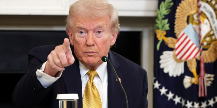 U.S. President Donald Trump points to a reporter in the State Dining Room of the White House on Oct. 23, 2025, in Washington, DC.