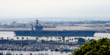 The USS Nimitz departs San Diego Bay at Mission Beach, in San Diego, California, on Aug. 19, 2023.