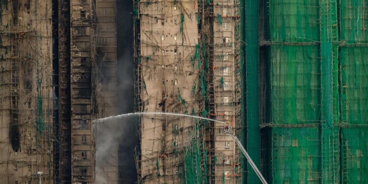 Hong Kong towers burn for a second day, at least 65 reported dead, hundreds missing