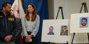 FBI Director Kash Patel looks at photographs of the two National Guard soldiers shot on Wednesday along with a photograph of their alleged assailant in Washington, DC on Nov. 27, 2025.