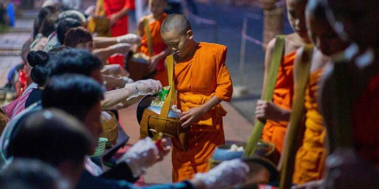 Buddhist monks in Laos pray in region littered with unexploded bombs