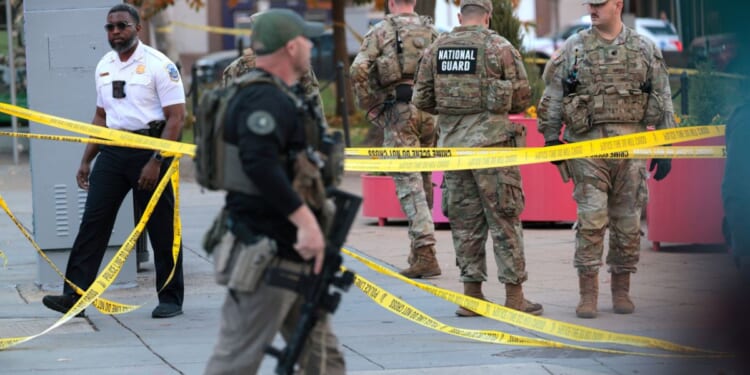 Members of law enforcement and National Guard soldiers respond to a shooting near the White House on Nov. 26, 2025, in Washington, D.C.