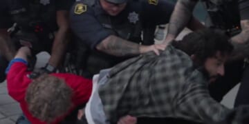 An antifa-linked man, right, and Trump supporter, left, are arrested by police at UC Berkeley at a Turning Point USA event on Monday.