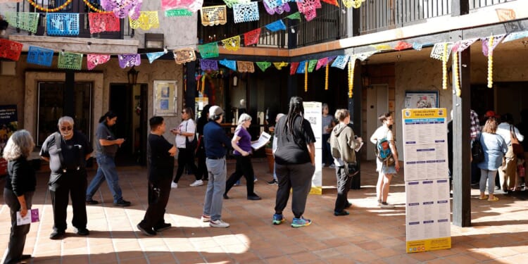 Voters wait in line to enter a polling place in Los Angeles, California, on Tuesday.