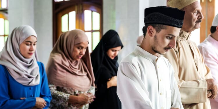 A muslim prayer takes place at a mosque.