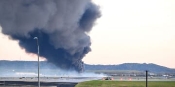 Fire and smoke mark where a UPS cargo plane crashed near Louisville Muhammad Ali International Airport on Nov. 4, 2025, in Louisville, Kentucky.