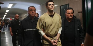 Luigi Mangione is escorted by police as he arrives for a Sept. 16 hearing at Manhattan Criminal Court in the killing of UnitedHealthcare CEO Brian Thompson.