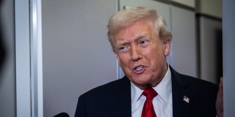 President Donald Trump speaks to reporters aboard Air Force One on its way to Florida on Nov. 25, 2025.