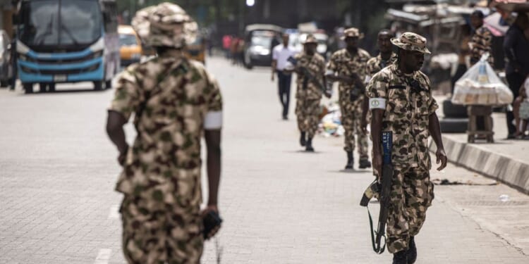 Soldiers from the Nigerian Armed Forces patrol and secure the streets in Lagos Island, Lagos, on Feb. 27, 2023, after hoodlums had harassed market owners.
