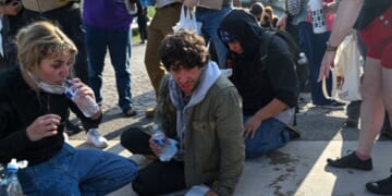 Demonstrators protesting outside the U.S Immigration and Customs Enforcement facility, including Democratic congressional candidate Kat Abughazaleh, 26, left, react after being tear-gassed on Sept. 19, 2025, in Broadview, Illinois.