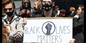A protester holds up a sign that says "Black Lives Matter" at a protest in Berlin on June 6, 2025.