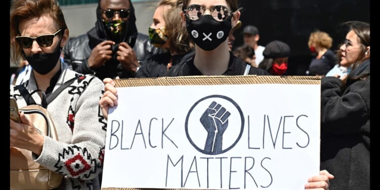 A protester holds up a sign that says "Black Lives Matter" at a protest in Berlin on June 6, 2025.
