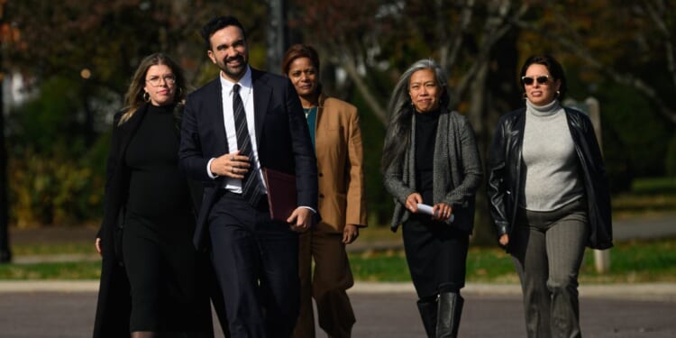 Mayor-elect of New York City Zohran Mamdani stands next to members of his transition team in the Queens borough of New York City on Nov. 5, 2025.