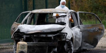 The car used by a man to run down pedestrians before he set it on fire and ran away on the French island of Ile d'Oleron is processed by authorities on Wednesday.