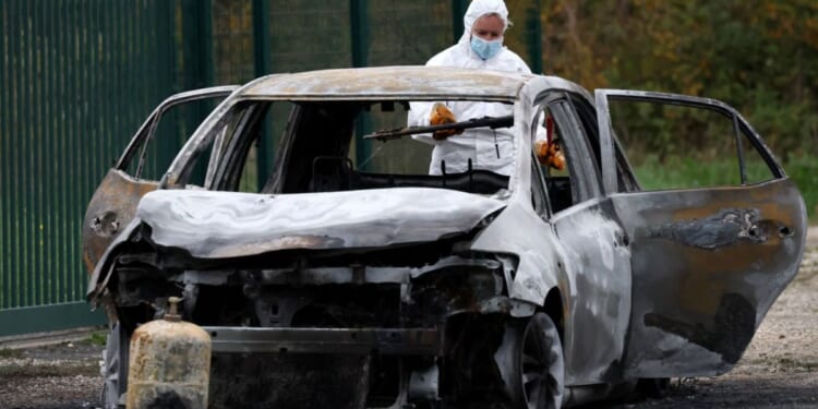 The car used by a man to run down pedestrians before he set it on fire and ran away on the French island of Ile d'Oleron is processed by authorities on Wednesday.