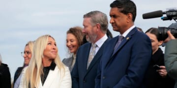 Rep. Marjorie Taylor Greene of Georgia speaks with fellow GOP Rep. Thomas Massie of Kentucky, center, and Democratic Rep. Ro Khanna of California in Washington, D.C.