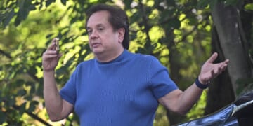 George T. Conway III, husband of former White House counselor Kellyanne Conway, speaks on the phone outside the home of John Bolton, Donald Trump's former national security advisor, after the FBI conducted a court-authorized search of the residence on Aug. 22, 2025, in Bethesda, Maryland.