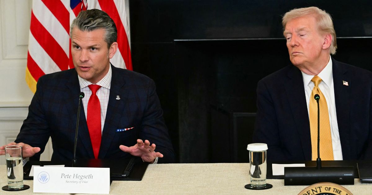 President Donald Trump listens to Defense Secretary Pete Hegseth during a law enforcement roundtable in the State Dining Room of the White House on Oct. 23, 2025, in Washington, D.C.