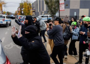 Protesters confronted immigration officers in the Little Village neighborhood of Chicago Saturday.