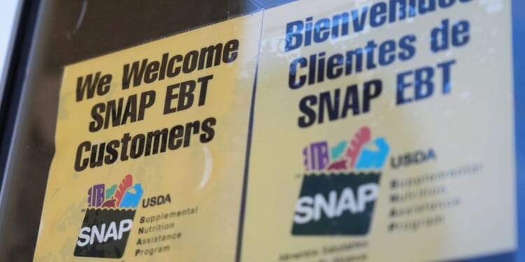 A sign welcoming customers who use SNAP sits outside of a convenience store in Baltimore on Nov. 10, 2025.