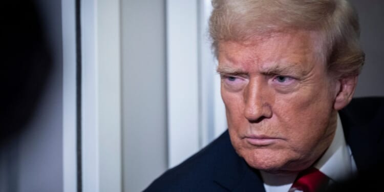 President Donald Trump speaks to reporters aboard Air Force One as it heads for Florida during his trip to Mar-a-Lago in Palm Beach, Florida, on Nov. 25, 2025.