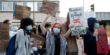 Protesters hold signs as they demonstrate outside of a Turning Point USA event at the University of California, Berkeley, on Nov. 10, 2025, in Berkeley, California.