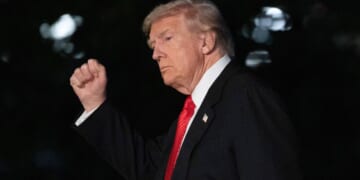 President Donald Trump gestures as he walks on the South Lawn of the White House in Washington, D.C., on Sunday.