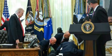 President Donald Trump looks on after a man fainted during an announcement about weight loss drugs in the Oval Office of the White House in Washington, D.C., on Nov. 6, 2025.