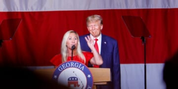 President Donald Trump looks on as Rep. Marjorie Taylor Greene speaks during his remarks at the Georgia state Republican convention at the Columbus Convention and Trade Center on June 10, 2023, in Columbus, Georgia.
