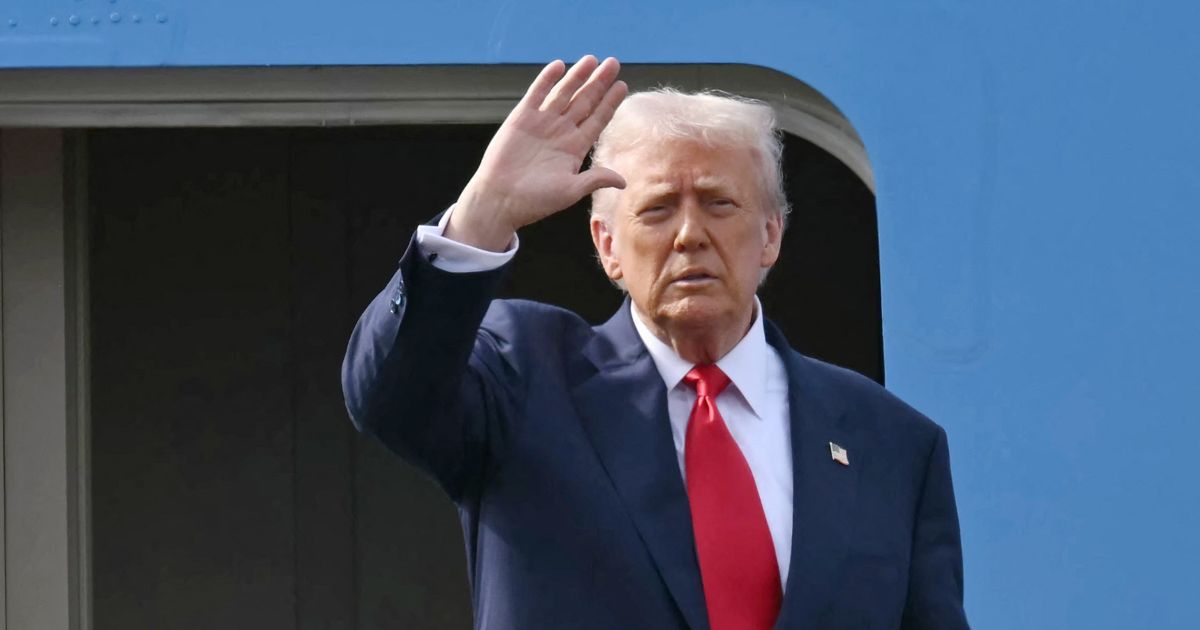 President Donald Trump waves as he boards Air Force One after talks with Chinese President Xi Jinping at the Gimhae Air Base, located next to the Gimhae International Airport in Busan on Oct. 30, 2025.