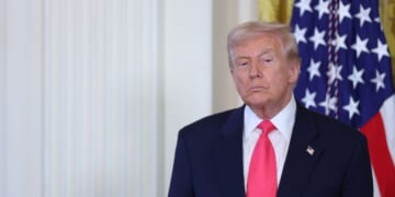 President Donald Trump listens as First Lady Melania Trump speaks at a signing ceremony for the "Fostering the Future" executive order in the East Room of the White House on Nov. 13, 2025, in Washington, D.C.