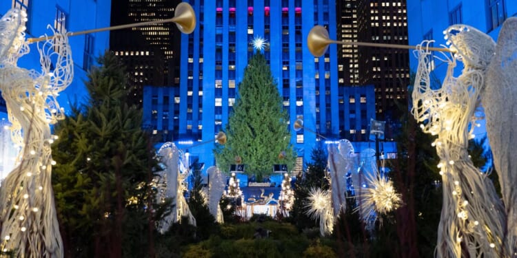 The Rockefeller Center Christmas tree, a holiday icon, lights up in New York