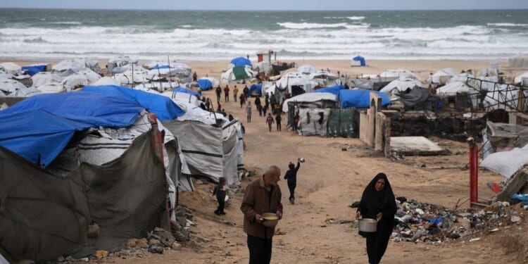 Rain floods Gaza camps as Benjamin Netanyahu heads for U.S. meeting