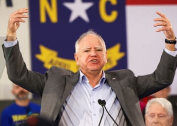 Minnesota Gov. Tim Walz gestures as he speaks during a Get-Out-The-Vote rally with former President Bill Clinton for Vice President Kamala Harris on the first day of North Carolina early voting in Durham, North Carolina, on Oct. 17, 2024.