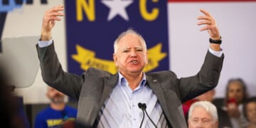 Minnesota Gov. Tim Walz gestures as he speaks during a Get-Out-The-Vote rally with former President Bill Clinton for Vice President Kamala Harris on the first day of North Carolina early voting in Durham, North Carolina, on Oct. 17, 2024.