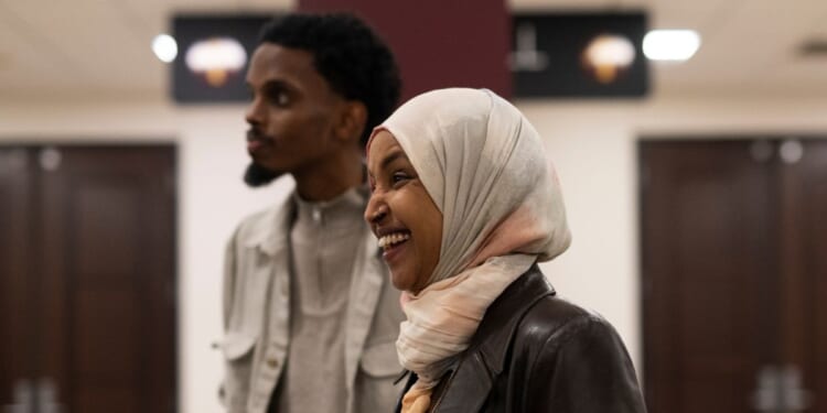 Rep. Ilhan Omar, a Democrat from Minnesota, laughs as she campaigns with Minneapolis mayoral candidate State Senator Omar Fateh on Election Day at the University of Minnesota on Nov. 4, 2025, in Minneapolis, Minnesota.
