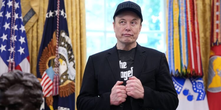 Elon Musk stands in the Oval Office of the White House as President Donald Trump speaks to reporters in Washington, DC on May 30, 2025.