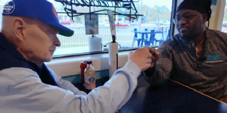 Longtime customer Charlie Hicks, left, fist bumps chef Donell Stallworth in a Shrimp Basket restaurant in Pensacola, Florida.