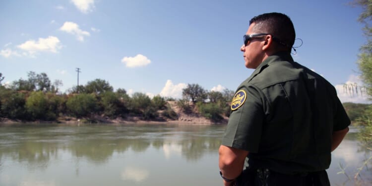 A Border Patrol agent looks out at the Rio Grande River in McAllen, Texas, on Sept. 21, 2016.