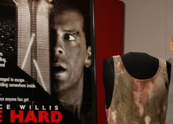 Actor Bruce Willis poses with objects from the "Die Hard" series of films that he donates to the Smithsonian's National Museum of American History June 27, 2007 in Washington, DC.