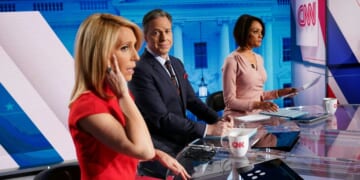 CNN news anchor Jake Tapper, flanked by Univision's news anchor Ilia Calderón, watches as co-anchor Dana Bash adjusts her ear piece before the start of the 11th Democratic Party 2020 presidential debate in a CNN Washington Bureau studio in Washington, D.C., on March 15, 2020.