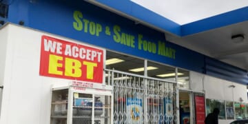 A sign noting the acceptance of EBT cards that are used by state welfare departments to issue benefits is displayed at a convenience store on Dec. 4, 2019, in Richmond, California.