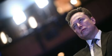 Elon Musk looks on as President Donald Trump speaks at the U.S.-Saudi Investment Forum at the John F. Kennedy Center for the Performing Arts in Washington, D.C., on Nov. 19, 2025.