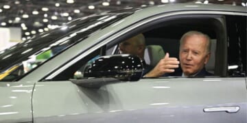 Then-President Joe Biden sits at the wheel of a Cadillac Lyriq electric vehicle as he visits the 2022 North American International Auto Show in Detroit, Michigan, on Sept. 14, 2022.