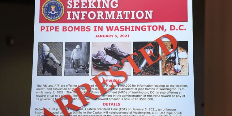 An FBI poster is displayed at the Department of Justice on Dec. 4 in Washington, D.C., during a press conference about the Jan. 6, 2021, pipe bomber case. Federal agents have charged Brian Cole with placing two pipe bombs, which never exploded, the night before the Jan. 6, 2021. U.S. Capitol incursion.