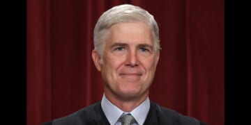 United States Supreme Court Associate Justice Neil Gorsuch poses for an official portrait in the Supreme Court building in Washington, DC on Oct. 7, 2022.