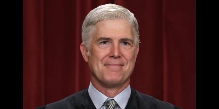 United States Supreme Court Associate Justice Neil Gorsuch poses for an official portrait in the Supreme Court building in Washington, DC on Oct. 7, 2022.