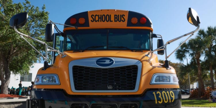 An electric bus is parked as Environmental Protection Agency Administrator Michael Regan visits during an event to highlight funding for electric school buses at the Coral Reef High School on March 11, 2024, in Richmond Heights, Florida.