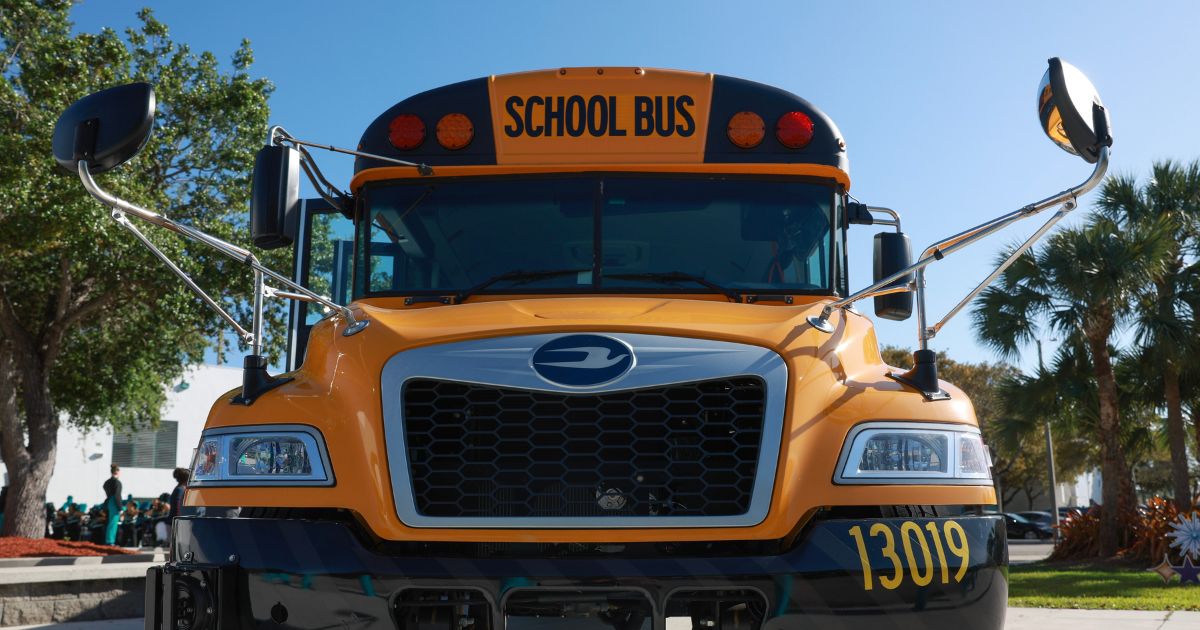 An electric bus is parked as Environmental Protection Agency Administrator Michael Regan visits during an event to highlight funding for electric school buses at the Coral Reef High School on March 11, 2024, in Richmond Heights, Florida.