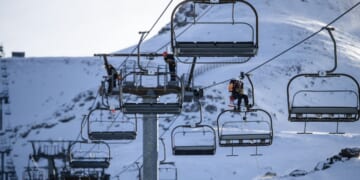 Ski lift operators practicing emergency response drills on a line of chairlift pylons at La Pierre Saint Martin in Arette, France, on Dec. 1, 2025.